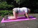 Starting position for cat down shown by yoga teacher in Cardiff