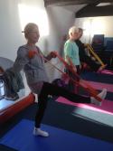 Lifted leg held up by student using a belt in Cardiff yoga class